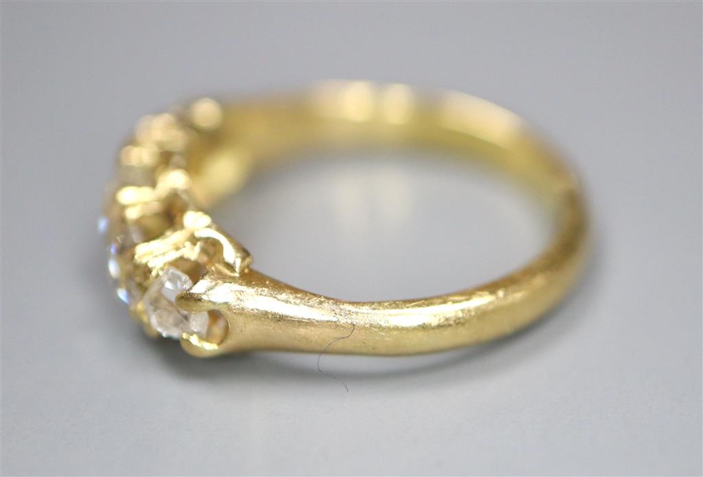 An 18ct and graduated five stone old cut diamond set childs ring, size E/F, gross 2.5 grams.